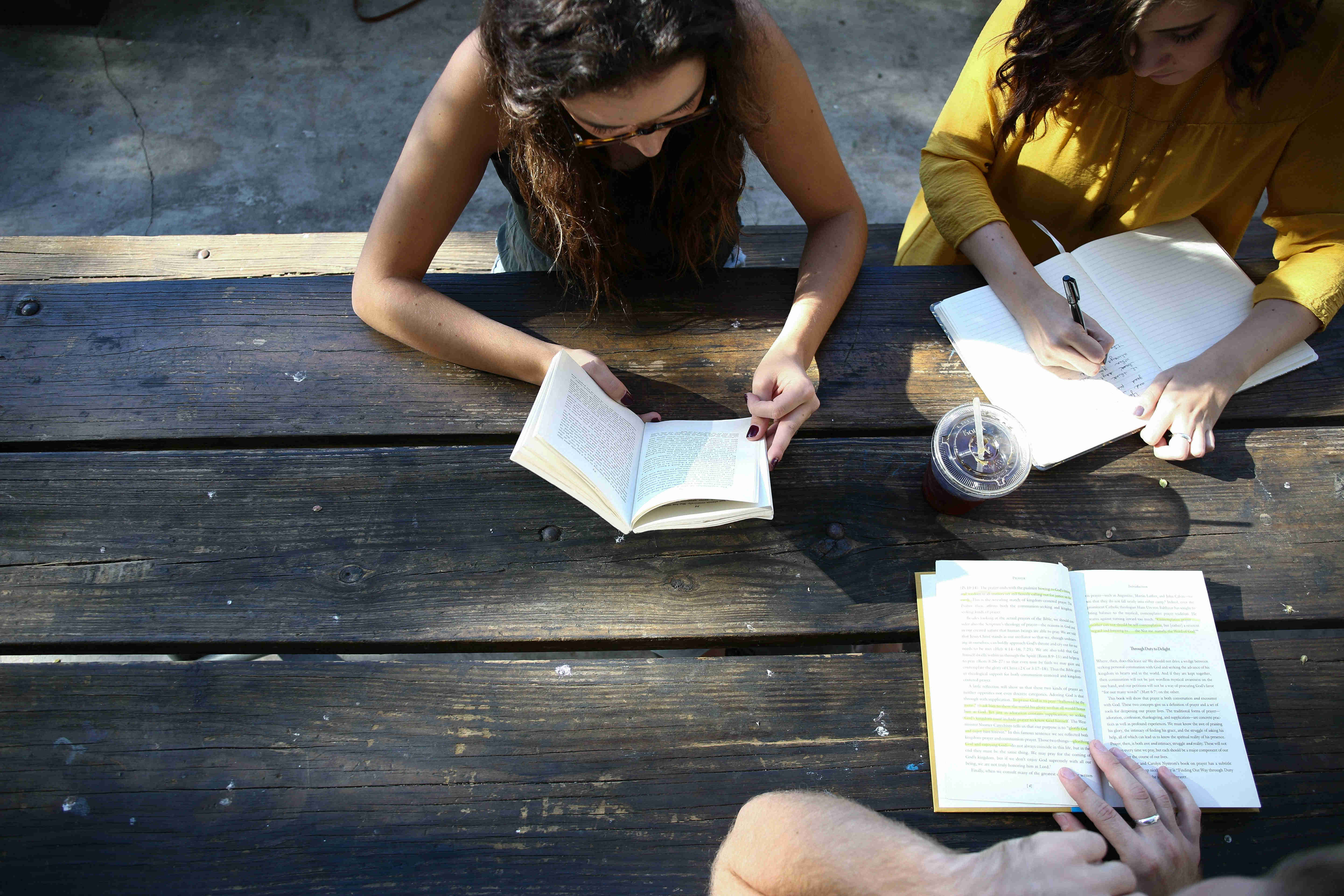 A group of people reading and studying at a table